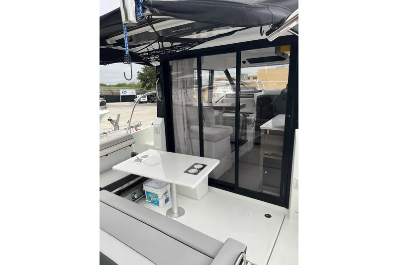  Yacht Photos Pics 2025 Jeanneau NC 895 Sport Series 2 boat interior with seating and table.