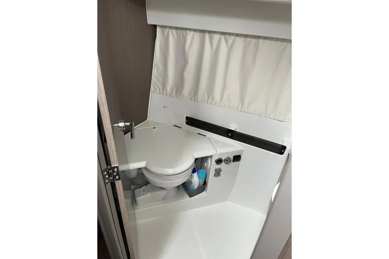  Yacht Photos Pics 2025 Jeanneau NC 895 Sport Series 2 boat bathroom interior with compact toilet.