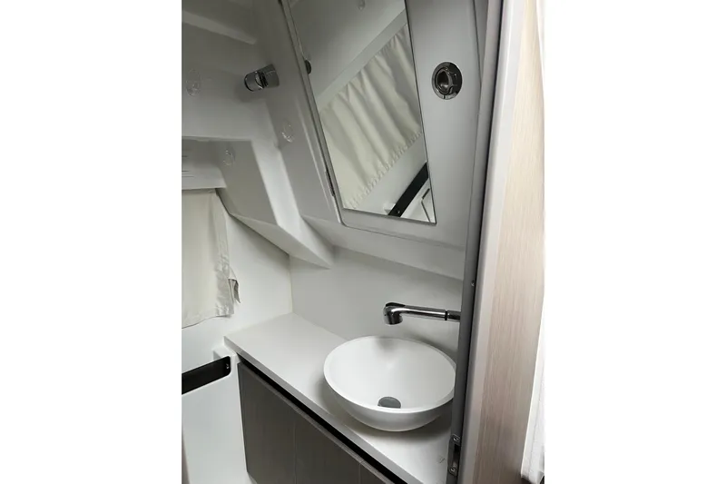  Yacht Photos Pics 2025 Jeanneau NC 895 Sport Series 2 bathroom with modern sink and mirror.