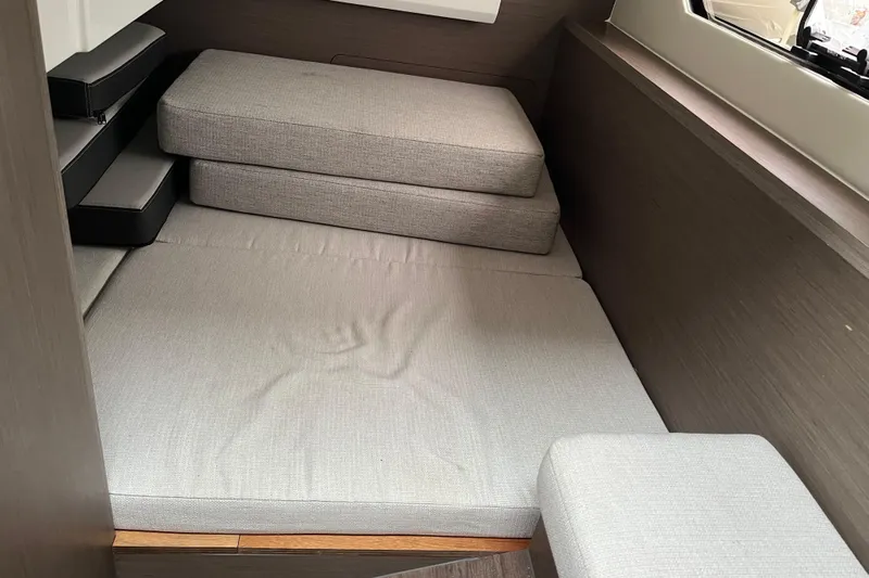  Yacht Photos Pics Interior cabin of 2025 Jeanneau NC 895 Sport Series 2 with gray cushions.