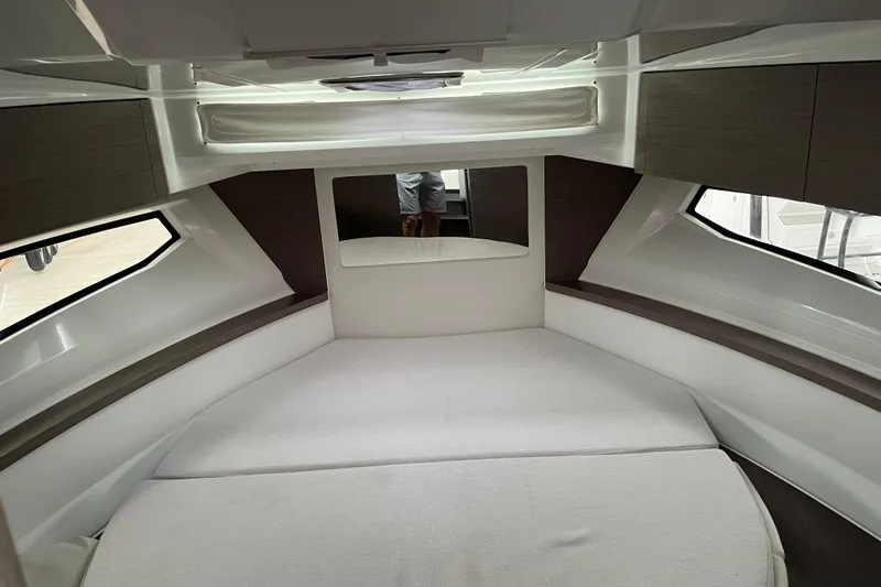  Yacht Photos Pics 2025 Jeanneau NC 895 Sport Series 2 cabin interior with modern design and comfortable bedding.