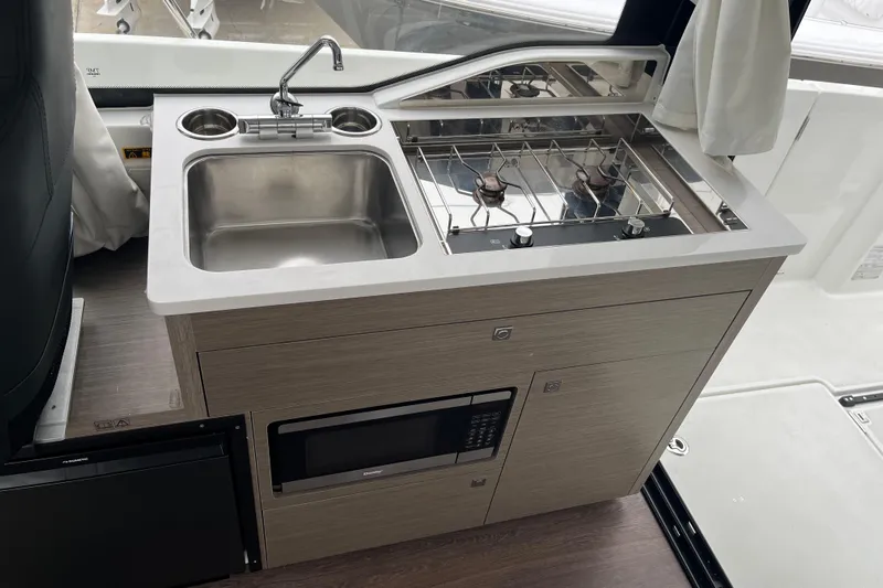  Yacht Photos Pics Compact kitchen area in the 2025 Jeanneau NC 895 Sport Series 2 boat.