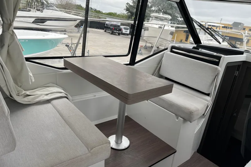  Yacht Photos Pics Interior of 2025 Jeanneau NC 895 Sport Series 2, featuring seating and table.