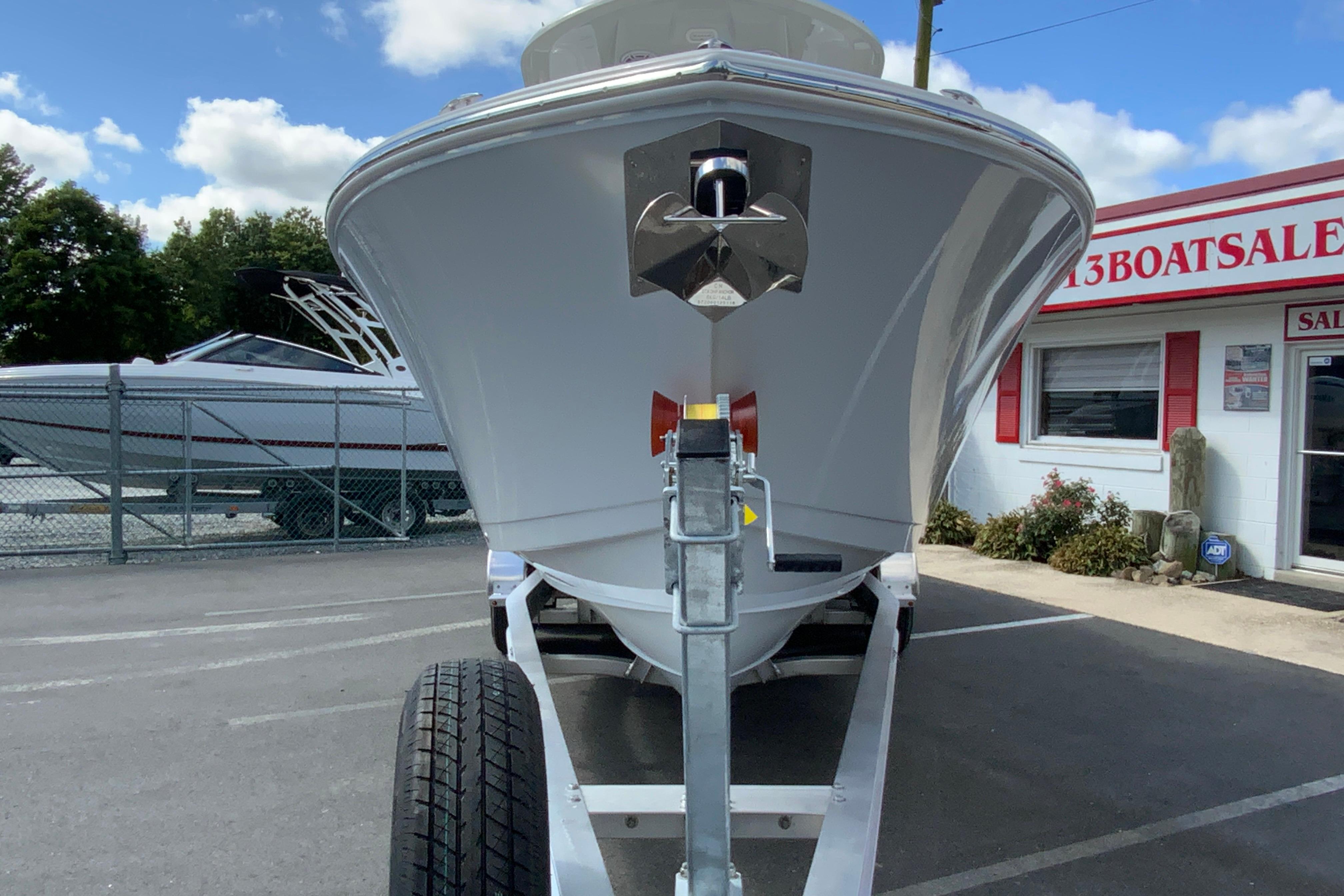 2026 Cobia 265 Open Center Console boat on trailer at dealership.