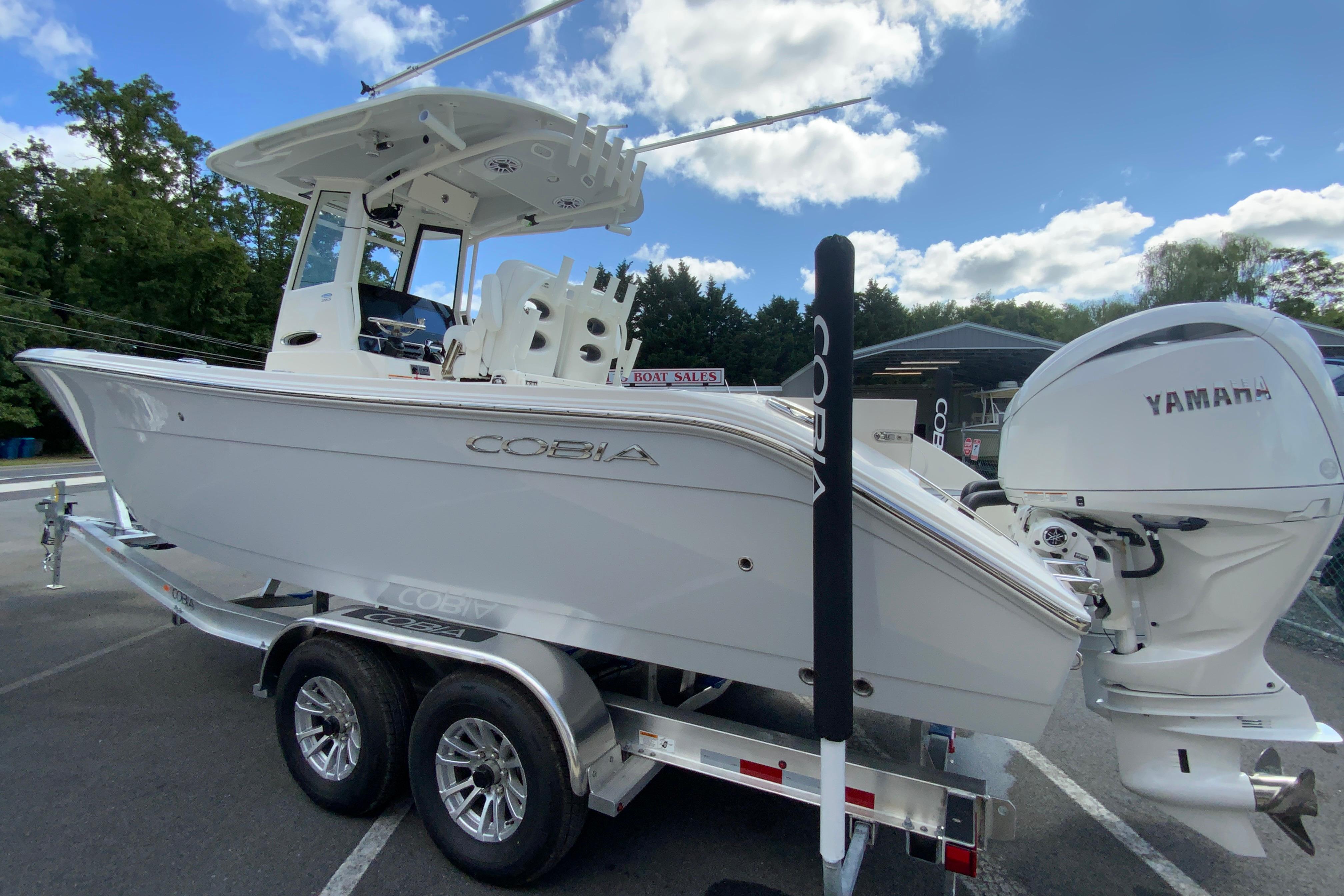 2026 Cobia 265 Open Center Console boat on trailer with Yamaha engine.