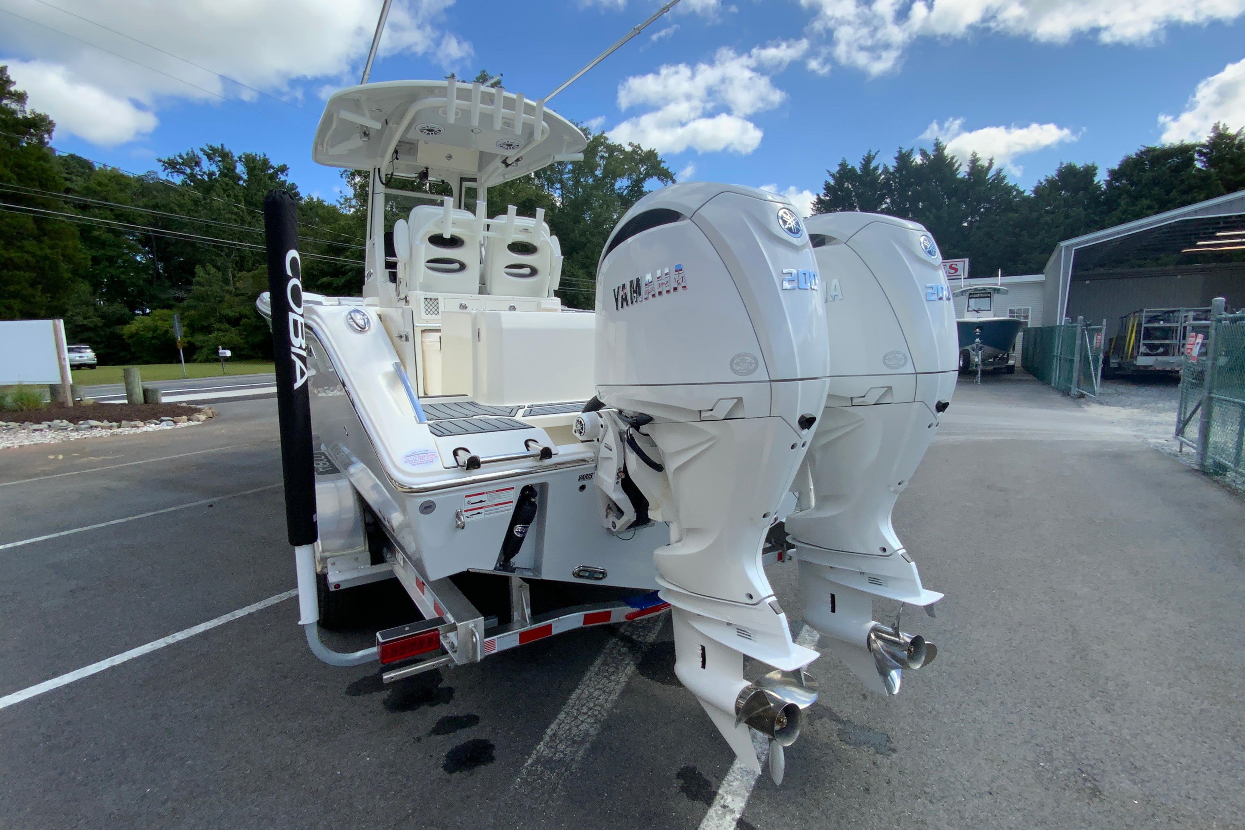 2026 Cobia 265 Open Center Console boat with dual Yamaha outboard engines.