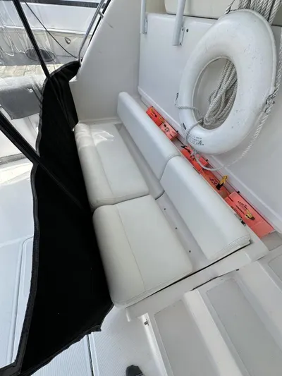 Superfishal II Yacht Photos Pics 1999 Tiara Yachts 4100 Open interior with white seating and life preserver.