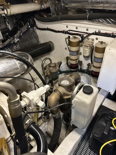 Superfishal II Yacht Photos Pics Engine room of a 1999 Tiara Yachts 4100 Open, showcasing mechanical components and filters.