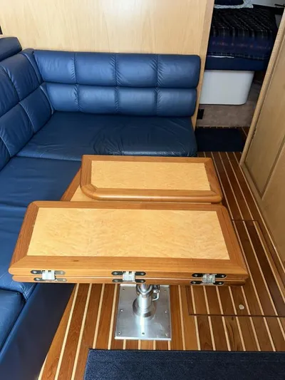 Superfishal II Yacht Photos Pics 1999 Tiara Yachts 4100 Open interior with blue seating and wooden table.