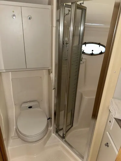 Superfishal II Yacht Photos Pics 1999 Tiara Yachts 4100 Open bathroom with shower, toilet, and storage cabinets.