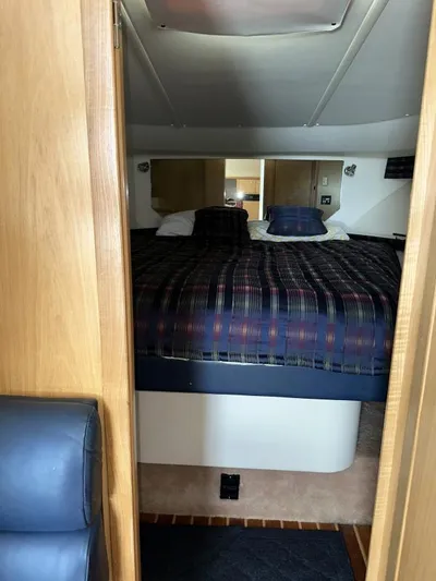 Superfishal II Yacht Photos Pics 1999 Tiara Yachts 4100 Open cabin interior with bed and wooden accents.