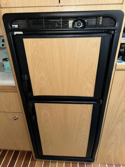 Superfishal II Yacht Photos Pics Wood-paneled refrigerator in a 1999 Tiara Yachts 4100 Open.