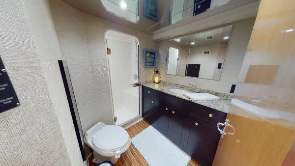 Reel Blonde Yacht Photos Pics 1999 Viking 72 Sport Fish yacht bathroom with shower, toilet, and vanity.