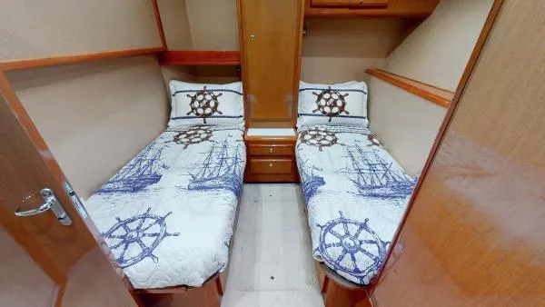 Reel Blonde Yacht Photos Pics Twin cabin beds in 1999 Viking 72 Sport Fish yacht with nautical-themed bedding.
