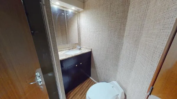 Reel Blonde Yacht Photos Pics Bathroom interior of 1999 Viking 72 Sport Fish yacht with sink and toilet.