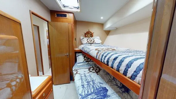 Reel Blonde Yacht Photos Pics Cabin interior of 1999 Viking 72 Sport Fish with bunk beds and nautical decor.