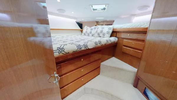 Reel Blonde Yacht Photos Pics Luxurious bedroom interior of 1999 Viking 72 Sport Fish yacht with wooden cabinetry.