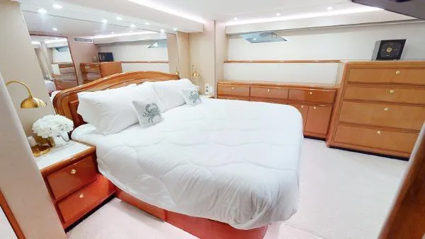 Reel Blonde Yacht Photos Pics Luxurious bedroom interior of 1999 Viking 72 Sport Fish yacht with king-size bed.