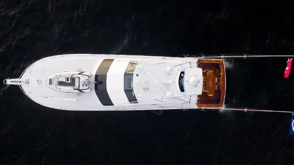 Reel Blonde Yacht Photos Pics Aerial view of 1999 Viking 72 Sport Fish yacht on dark water.