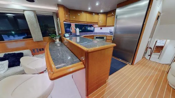 Reel Blonde Yacht Photos Pics 1999 Viking 72 Sport Fish yacht interior with modern kitchen and seating area.