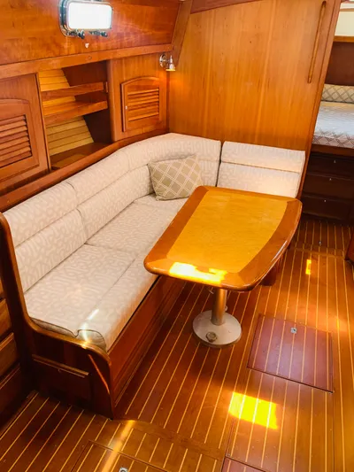 Sparrow Yacht Photos Pics 2004 Sabre 42 Hardtop Express interior with wooden dining area and cushioned seating.