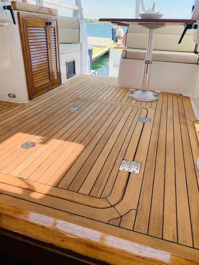 Sparrow Yacht Photos Pics Teak deck of 2004 Sabre 42 Hardtop Express yacht with seating and table.