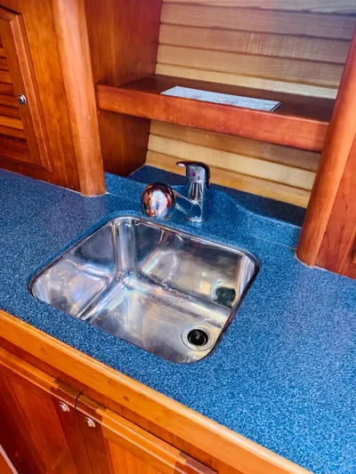 Sparrow Yacht Photos Pics 2004 Sabre 42 Hardtop Express yacht interior with stainless steel sink and wooden cabinetry.