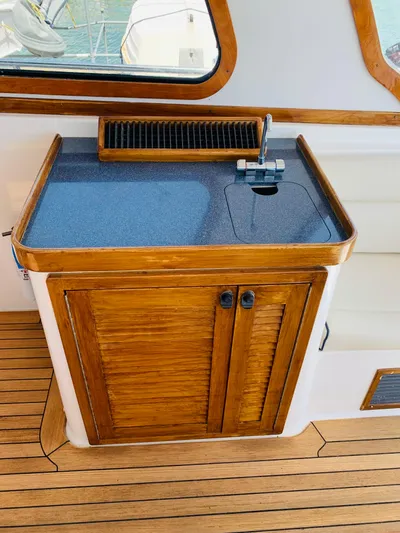 Sparrow Yacht Photos Pics 2004 Sabre 42 Hardtop Express yacht interior with wooden cabinetry and sink.