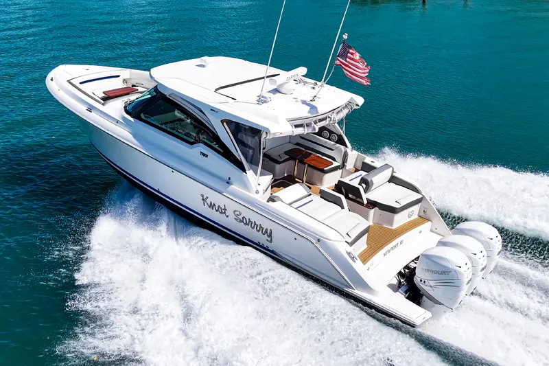 Knot Sorry Yacht Photos Pics 2022 Tiara Yachts 38 LX cruising on clear blue water, displaying sleek design and powerful engines.