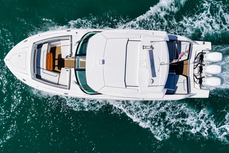 Knot Sorry Yacht Photos Pics Aerial view of 2022 Tiara Yachts 38 LX cruising on turquoise water.
