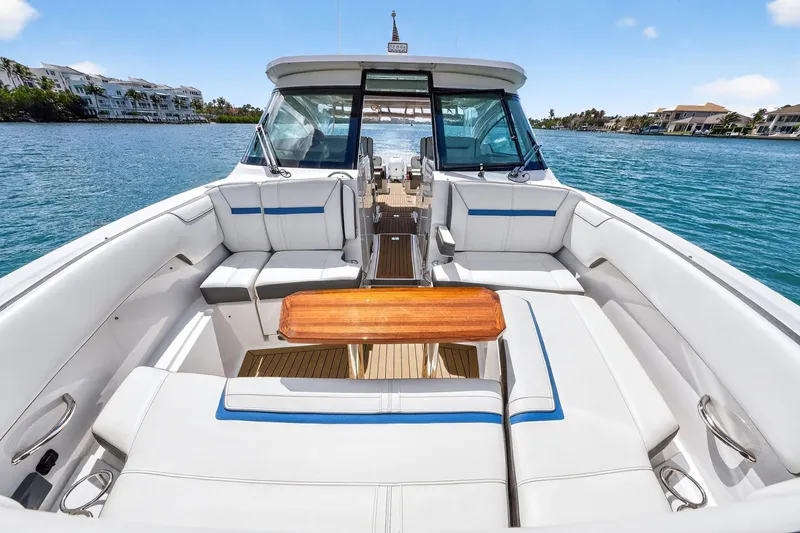 Knot Sorry Yacht Photos Pics 2022 Tiara Yachts 38 LX with luxurious seating on a serene water backdrop.