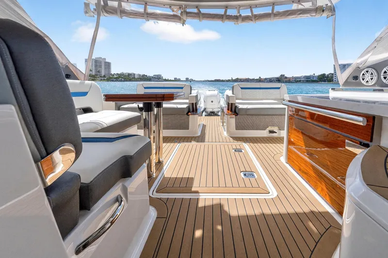 Knot Sorry Yacht Photos Pics Luxurious 2022 Tiara Yachts 38 LX interior with elegant seating and scenic water view.