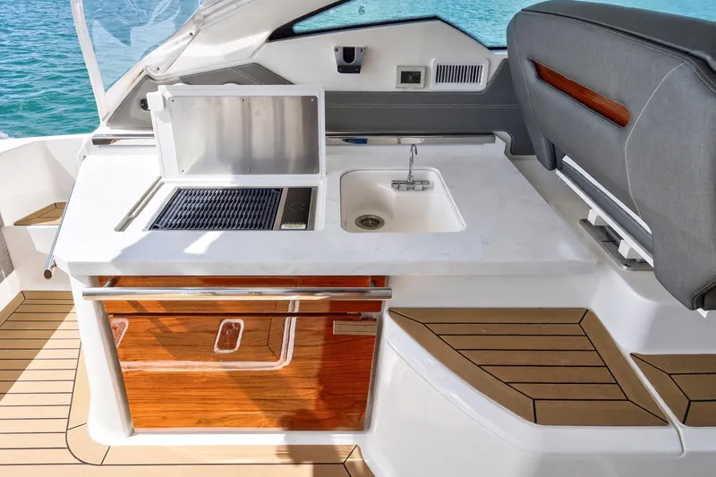 Knot Sorry Yacht Photos Pics 2022 Tiara Yachts 38 LX boat interior with sink and grill station.