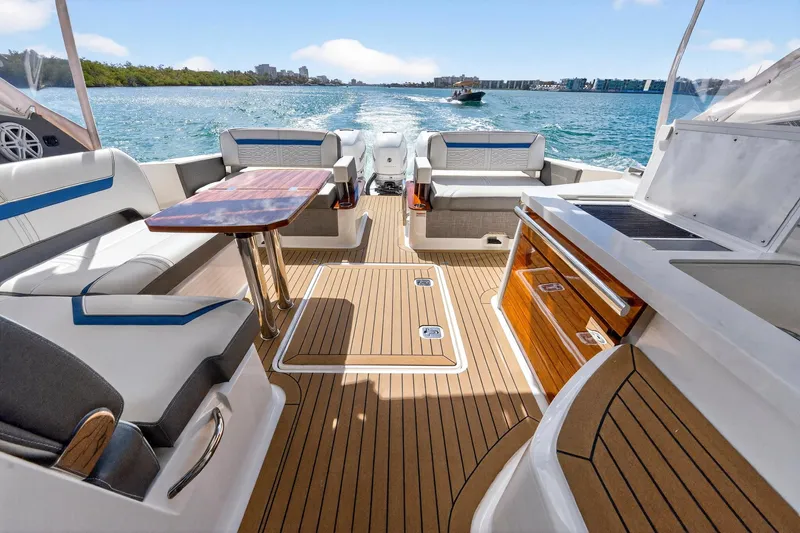 Knot Sorry Yacht Photos Pics 2022 Tiara Yachts 38 LX interior with luxurious seating and wooden deck on open water.