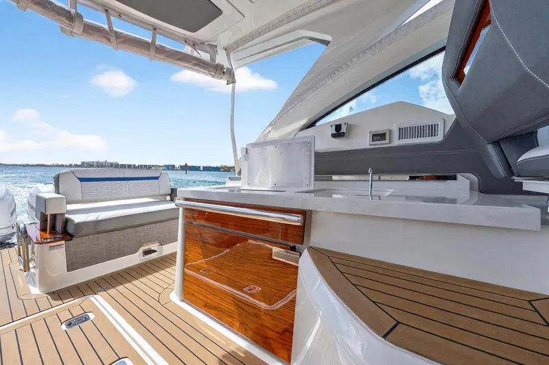 Knot Sorry Yacht Photos Pics 2022 Tiara Yachts 38 LX interior with luxurious seating and sleek design.