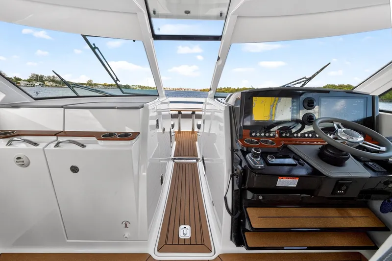 Knot Sorry Yacht Photos Pics 2022 Tiara Yachts 38 LX helm with modern navigation system and sleek interior design.