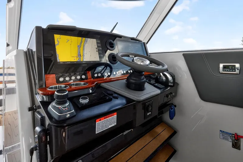 Knot Sorry Yacht Photos Pics 2022 Tiara Yachts 38 LX helm with navigation display and controls.