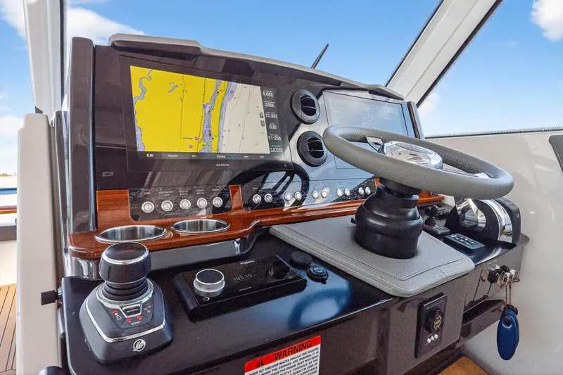 Knot Sorry Yacht Photos Pics 2022 Tiara Yachts 38 LX helm with advanced navigation and control systems.