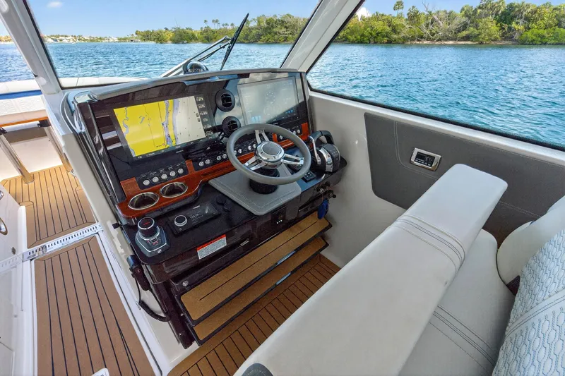 Knot Sorry Yacht Photos Pics 2022 Tiara Yachts 38 LX helm with advanced navigation system and luxurious seating.