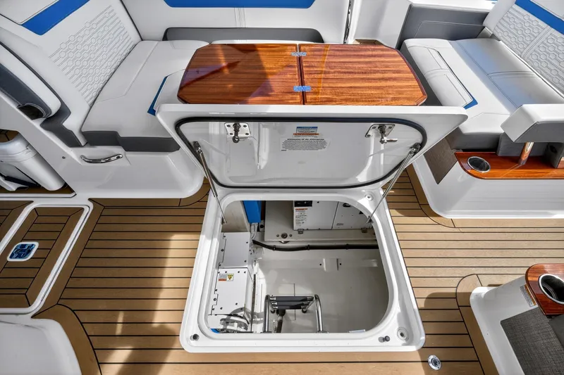 Knot Sorry Yacht Photos Pics 2022 Tiara Yachts 38 LX interior with open hatch, showcasing sleek seating and wood accents.