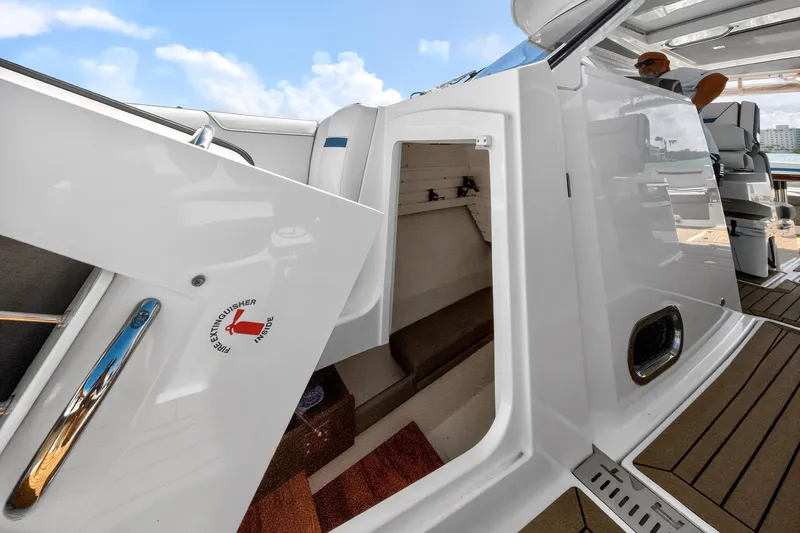 Knot Sorry Yacht Photos Pics 2022 Tiara Yachts 38 LX interior view with open cabin door and deck.