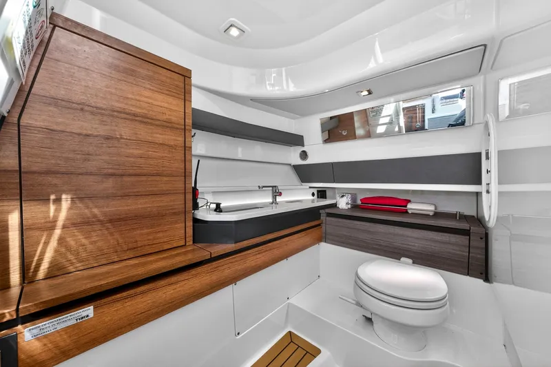 Knot Sorry Yacht Photos Pics Luxurious 2022 Tiara Yachts 38 LX bathroom with modern wood and sleek design.