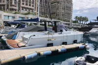 2019 Fjord 36' Open yacht docked in marina, with luxury buildings in background.