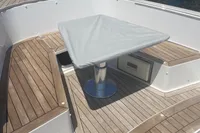2019 Fjord 36' Open yacht with teak deck and covered table, docked at marina.