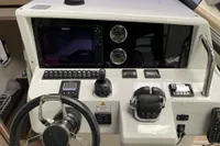 Control panel of a 2019 Fjord 36' Open boat with steering wheel and navigation instruments.