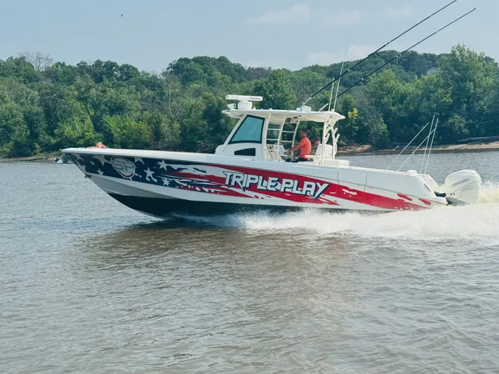 Triple Play Yacht Photos Pics 2015 Boston Whaler 370 Outrage boat with "Triple Play" graphics on a river.
