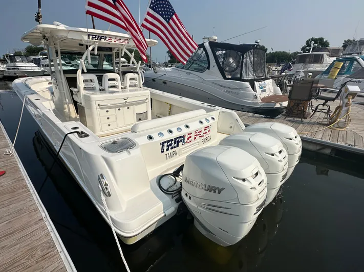 Triple Play Yacht Photos Pics 2015 Boston Whaler 370 Outrage with triple Mercury engines docked at marina.