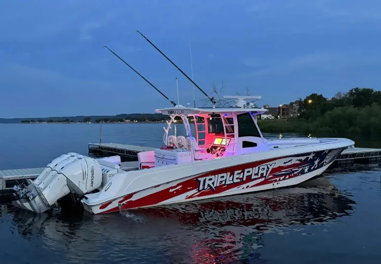 Triple Play Yacht Photos Pics Boston Whaler 370 Outrage 2015 boat docked at sunset with vibrant graphics and triple engines.