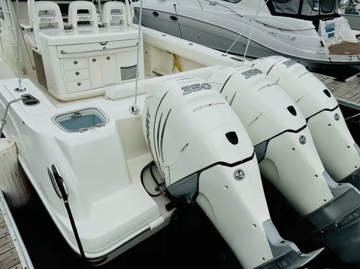 Triple Play Yacht Photos Pics 2015 Boston Whaler 370 Outrage with triple outboard engines docked at marina.