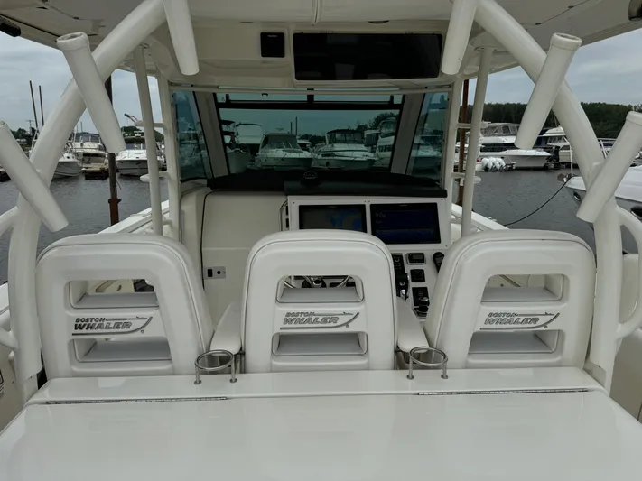 Triple Play Yacht Photos Pics 2015 Boston Whaler 370 Outrage boat interior with helm and seating at marina.